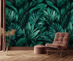 a chair and ottoman in front of a wall with green leaves on it's side