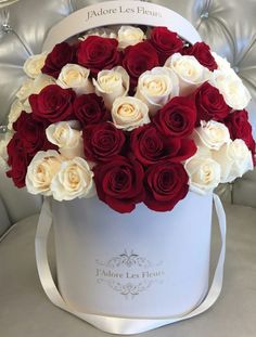 a white and red box with roses in it