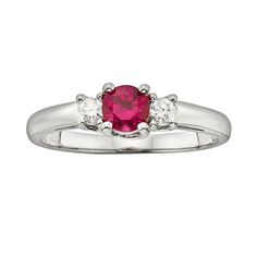 Show her how much she means to you with this gorgeous 3-stone ring.Ring Details: Width: 5.1 mm Metal: rhodium-plated 14k white gold Features: colored gem reportStone Details: IGL Certified Stone type: genuine ruby Total weight: 1/2 ct. Cut: round Setting: prongDiamond Details: IGL certified Total weight: 1/6 ct. Cut: round Color: I Clarity: I1 Setting: prongImage(s) may be enlarged to show detail.Diamond weights are approximate. Diamond total weights may vary between .01 and .08 ct. Some diamond Classic Three Stone Ruby Ring With Diamonds, Red Three-stone Diamond Promise Ring, Classic Three Stone Ruby Promise Ring, Red Three Stone Diamond Promise Ring, Red Three Stone Diamond Ring For Promise, Classic Red Three Stone Diamond Ring, Classic Red Three Stone Rings, Classic Red Three-stone Ring, Red Three-stone Diamond Ring For Anniversary