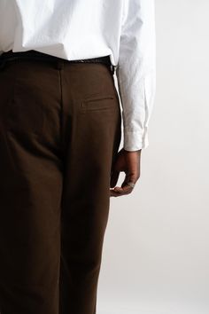 A slightly relaxed, subtly tapered pant cut from a brown organic cotton moleskin. Featuring 1/2" pleats, quarter top front pockets, single ‘hand style’ welt pocket on back right side, French seams, veg-tan leather washer backed YKK buttons, clean finish button fly and single needle belt loops. Organic Cotton Moleskin Made in California Hand numbered edition of 39 Hand Style, Veg Tan Leather, French Seam, Pleated Pants, Signature Look, Moleskine, Right Side, Welt Pocket, Tan Leather