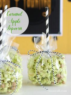 two bags filled with green candy sitting on top of a table next to each other