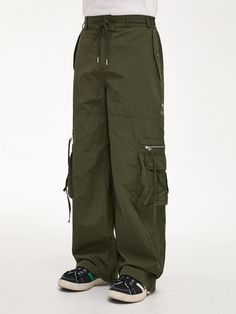 These are loose silhouette cargo pants featuring asymmetric pocket details. They are topped with comfortable half banding waistband with drawstring for easy size adjustment.   - Zip and button fastenings- Elasticated back waistband and adjustable drawstring- Two front flap pockets- Four back patch pockets - Two side cargo pockets- Logo embroidery- Adjustable drawcord at hem- Wide fit- Unisex wear Baggy Utility Cargo Pants With Drawstring, Green Utility Parachute Pants With Drawstring, Utility Wide Leg Parachute Pants With Drawstring, Baggy Utility Parachute Pants With Functional Drawstring, Baggy Techwear Cargo Pants With Drawstring, Baggy Nylon Utility Cargo Pants, Baggy Nylon Cargo Pants With Side Pockets, Utility Parachute Pants With Functional Drawstring, Utility Parachute Pants With Drawstring For Streetwear