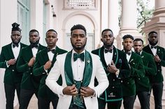 a group of men in green and white tuxedos