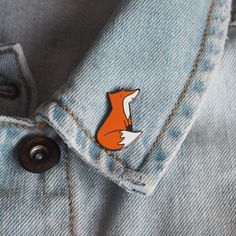 a red fox sticker on the back of a blue jean jacket with black buttons