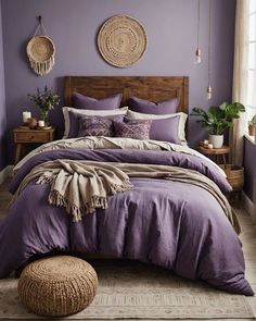 a bed with purple sheets and pillows in a room