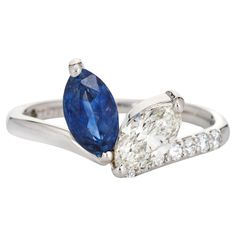 an engagement ring with two pear shaped blue and white diamonds