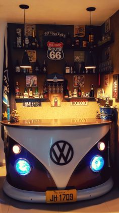 a vw bus bar with beer bottles on the wall and lights in the front