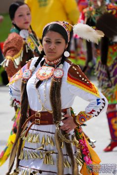 a group of people dressed in native american clothing