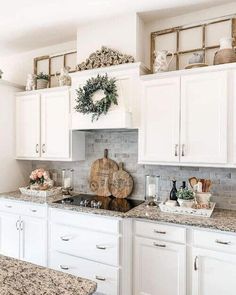 a kitchen with white cabinets and granite counter tops, decorated for christmas or new year's eve