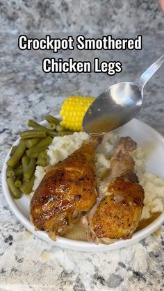 a white plate topped with chicken, green beans and mashed potatoes