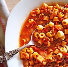 a white bowl filled with pasta and sauce