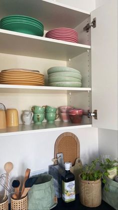 the shelves in the kitchen are filled with dishes