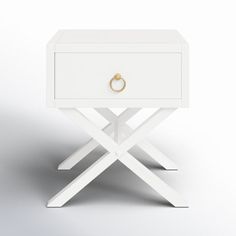 a white wooden table with a ring on it's drawer and two crossed legs