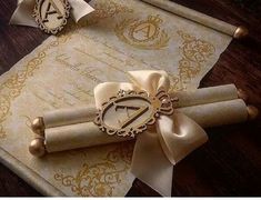 an old scroll with a clock on it and ribbon tied around the letter, sitting on top of a piece of parchment paper