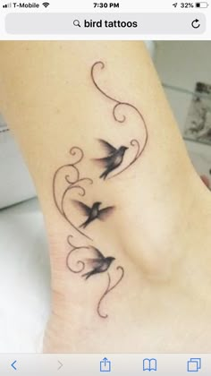 a woman's foot with two birds on it and swirls around the ankles