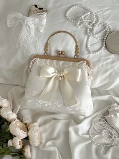 All of our products are thoughtfully and ethically made by hand in Illinois. Frame Bag is made is made out of Ivory Jacquard Fabric and the lining is made of satin fabric.  size: 8 inch x 9 inch x 4inch Cheap Vintage Shoulder Bag For Wedding, Bridal Handbags Handmade, White Satchel With Pearl Handle, White Satchel Bag With Pearl Handle, Cream Box Bag With Removable Pouch, Classic Top Handle Evening Bag As Gift, White Top Handle Satchel For Gift, White Top Handle Satchel As Gift, Elegant White Handheld Satchel