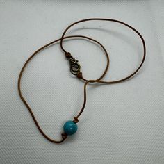 Synthetic Turquoise Bead On A Light Brown Leather Cord Necklace. Brand Never Never Worn. Adjustable Brown Turquoise Bohemian Necklace, Handmade Adjustable Brown Turquoise Necklace, Casual Turquoise Beaded Necklaces For Festival, Casual Adjustable Brown Necklace, Adjustable Single Strand Turquoise Bohemian Necklace, Bohemian Adjustable Single Strand Turquoise Necklace, Adjustable Bohemian Single Strand Turquoise Necklace, Everyday Bohemian Turquoise Necklace, Casual Blue Necklace For Everyday Wear