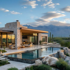 a house with a pool in the front yard and mountains in the backgroud