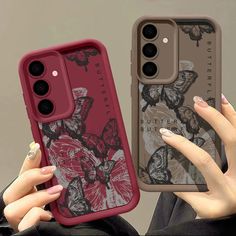 two women holding up their phone cases with butterflies on them