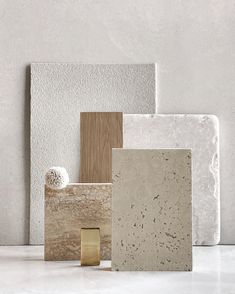 several different types of tile on a counter top with white walls and flooring in the background