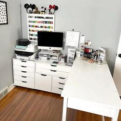 a white desk topped with lots of drawers