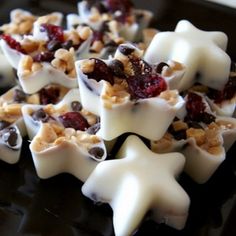 white chocolate with cranberries and walnuts on a black plate