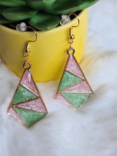 Elevate your style with these stunning handmade resin pink and green dangle earrings that beautifully capture the essence of elegance. The vibrant combination of pink and green creates a striking and eye-catching accessory, perfect for adding a bold touch to your everyday look. -crafted with UV Resin, Alloy Hypoallergenic All earrings are handmade by me and there may be minor variations. Colors may vary slightly from photos. Contact me if you have any questions.  Care instructions: Clean with a Trendy Pink Resin Jewelry, Green Geometric Jewelry For Gifts, Green Geometric Jewelry For Gift, Green Geometric Jewelry Gift, Geometric Green Jewelry Gift, Pink Resin Dangle Jewelry, Handmade Green Geometric Earrings, Trendy Green Geometric Jewelry, Trendy Geometric Green Jewelry