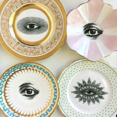 four plates with different designs on them and one has an eye in the center,