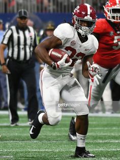 a football player running with the ball during a game