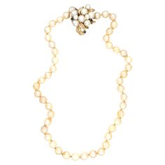 This timeless 18-inch pearl strand necklace showcases 48 lustrous cream-colored, round cultured pearls, each measuring 7 mm in diameter, offering a sophisticated and refined look. The necklace is completed with a unique pearl and sapphire clasp, featuring pearls ranging from 4.5 to 6.5 mm and accented by 0.12 carats of vibrant blue sapphires, adding a touch of color and elegance to the clasp. Crafted in the 1970s and stamped "14K,” this necklace weighs 35.46 grams, providing a comfortable yet lu Vintage Akoya Pearl Drop Necklace, Classic Cream Pearl Chain Necklace, Cream Single Strand Pearl Necklace, Classic Cream Pearl Necklace With Pearl Charm, Formal Single Strand Cream Pearl Necklace, Formal Cream Single Strand Pearl Necklace, Fine Jewelry Single Strand Pearl Necklace With Round Beads, Classic Cream Pearl Necklace, Cream Pearl Necklace For Formal Occasions