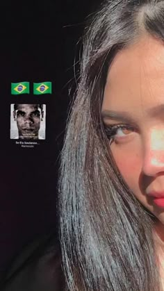 a close up of a person with long hair and an brazil sticker on their face