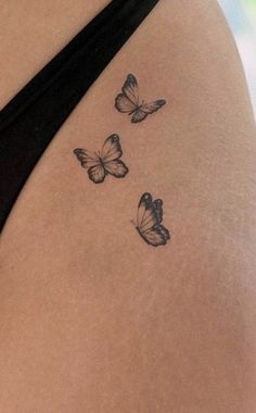 a woman's stomach with three butterflies on it