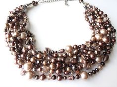 Pearl statement necklace, crystal necklace, multi strand necklace, unique gift idea, handmade jewelry, beaded necklaceThis necklace is by far one of my favorites. The mocha tones with brown and rose are subltle with a hint of sparkle and make an outfit look so classy and sophisticated. This one is a show-stopper! 8 strands of stunning freshwater and glass pearls light up with splashes of sparkling crystals. Gorgeous for an evening out, a special event/occasions, or as a BOLD statement with your Brown Multi-strand Beaded Necklace For Gift, Elegant Brown Beaded Necklace For Party, Brown Multi-strand Necklace For Party, Elegant Brown Multi-strand Beaded Necklaces, Brown Multi-strand Necklace Gift, Elegant Brown Beaded Crystal Necklaces, Elegant Brown Beaded Crystal Necklace, Elegant Brown Crystal Necklace For Gift, Statement Jewelry Necklace