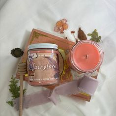 a candle and some other items on a bed