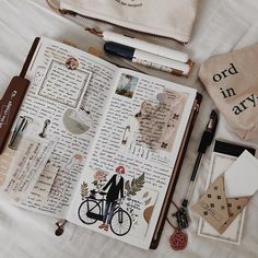 an open book with writing on it next to some other items and accessories in front of it