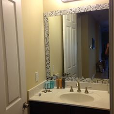 a bathroom sink with a large mirror above it