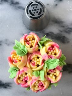 a bunch of food that is on top of a marble table with a canister in the background