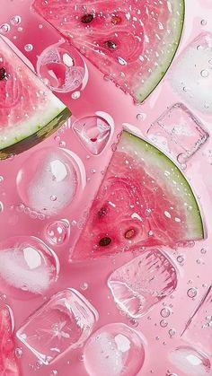 slices of watermelon and ice cubes on a pink surface with drops of water