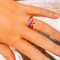 This gorgeous dainty sparkling pink topaz flower ring is perfect for everyday wear or for a special occasion. Makes the perfect gift for any occasion. * 18K Rose Gold Filled * Flower size is approximately 1x1cm * Simulated Topaz * Nickle and Lead Free *Size 6 and 7 only * Photos enlarged to show detail * Ring box included *For returns/refunds please contact me within 3 days, please ship items back in original condition within 7 days of receipt. Adjustable Crystal Flower Ring, Adjustable Pink Rings For Proposal, Adjustable Pink Flower Ring For Wedding, Pink Flower-shaped Promise Ring, Elegant Adjustable Pink Flower Ring, Adjustable Flower Crystal Ring, Pink Flower Rings For Anniversary, Delicate Pink Flower Ring For Wedding, Pink Flower Promise Ring