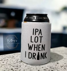 a can cooler sitting on top of a counter next to a sign that says, i pa lot when i drink