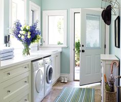 a washer and dryer are in the middle of a room with blue walls