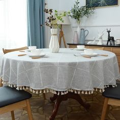 a table with two chairs and a vase on it