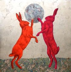 two red rabbits are playing with a ball