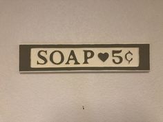 a sign that says soap 5 cents hanging on the wall