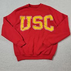 Features: - Crew Neck - 60% Cotton/40% Polyester - Usc Graphic Red College Sweatshirt With Letter Print, Casual Yellow Sweater With Letter Print, Red Long Sleeve Sweatshirt For Campus, Casual Yellow Letter Print Sweater, Red Varsity Sweatshirt With Graphic Print, Red Cotton Sweatshirt For Campus, Collegiate Style University Red Sweatshirt With Letter Print, Collegiate University Red Sweatshirt With Letter Print, Collegiate Sweatshirt With Letter Print In University Red