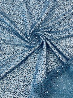 blue and white speckled fabric with small dots on the center, as if it were glitter