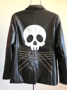 Unique & beautiful punk rock Jacket. Faux Black Jacket. Skull hand painted and embellished. Size M, US letter woman size. Fitted Black Biker Jacket For Halloween, Fitted Edgy Leather Jacket For Halloween, Halloween Grunge Outerwear With Skull Print, Grunge Halloween Outerwear With Skull Print, Edgy Halloween Outerwear With Graphic Print, Fitted Black Leather Jacket For Halloween, Fitted Rocker Leather Jacket For Alternative Fashion, Alternative Halloween Outerwear With Graphic Print, Halloween Rocker Style Black Outerwear