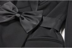 Brooke Black Bow Mini Blazer Dress for Women - Slim Fit Our Ladies' Suit Dress is made with a pointed collar, waist belt, and a large butterfly bow, all crafted from luxurious faux silk satin fabric, while the main body is constructed with a sturdy suit fabric. With a length that falls below the hips, this dress can be worn as a stylish outerwear piece or as a skirt, making it a versatile addition to your wardrobe. The tailored fit highlights the feminine silhouette, and the waist belt cinches a Women Business Dress, Black Blazer Style, Mini Blazer, Black Blazer Dress, Business Wardrobe, Business Dress Women, Skirt Making, Ladies Suit, Womens Faux Fur Coat