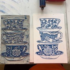 three blue and white teacups are sitting next to each other on a table