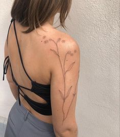 a woman with a flower tattoo on her back